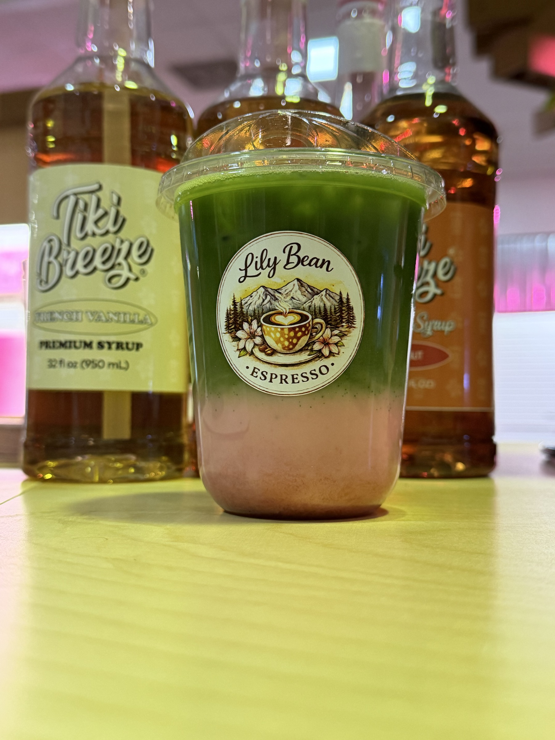 Lilybean matcha latte with vanilla and syrup bottles